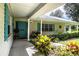 Covered front porch with rocking chairs and lush landscaping at 310 Willow Oak Ct, Fort Meade, FL 33841