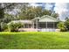 Spacious backyard with a large screened patio, above ground pool, and lush lawn at 310 Willow Oak Ct, Fort Meade, FL 33841