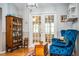 Cozy sitting area with blue armchairs and a wooden cabinet at 310 Willow Oak Ct, Fort Meade, FL 33841