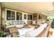 Cozy screened porch furnished with wicker seating and coffee table at 310 Willow Oak Ct, Fort Meade, FL 33841