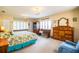 Large main bedroom with window seat, wood furniture, and a charming chandelier at 310 Willow Oak Ct, Fort Meade, FL 33841