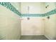 Large walk-in shower with teal and gray tile at 310 Willow Oak Ct, Fort Meade, FL 33841