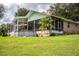 House with a screened patio, above ground pool, and expansive lawn at 310 Willow Oak Ct, Fort Meade, FL 33841