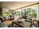 Large screened porch with ample seating and a view of lush greenery at 310 Willow Oak Ct, Fort Meade, FL 33841