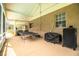 Screened patio with ping pong table, grill, and backyard access at 310 Willow Oak Ct, Fort Meade, FL 33841