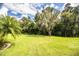 Expansive backyard with lush lawn and mature trees at 310 Willow Oak Ct, Fort Meade, FL 33841