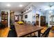 Large farmhouse dining table surrounded by black chairs at 310 Willow Oak Ct, Fort Meade, FL 33841