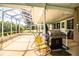 Screened patio with grill and table and chairs, overlooking backyard at 310 Willow Oak Ct, Fort Meade, FL 33841