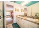 Double vanity bathroom with view into bedroom and teal accents at 310 Willow Oak Ct, Fort Meade, FL 33841