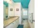 Bright bathroom with double sinks, teal accents, and updated flooring at 310 Willow Oak Ct, Fort Meade, FL 33841