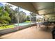 Screened patio with ping pong table, pool, and a view of the backyard at 310 Willow Oak Ct, Fort Meade, FL 33841