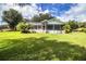 Spacious backyard with a screened patio, above ground pool, and lush lawn at 310 Willow Oak Ct, Fort Meade, FL 33841