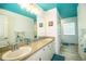 Double vanity bathroom with teal ceiling and updated flooring at 310 Willow Oak Ct, Fort Meade, FL 33841