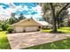 Three-car garage and expansive yard with mature trees at 310 Willow Oak Ct, Fort Meade, FL 33841