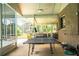Screened porch with ping pong table and backyard access at 310 Willow Oak Ct, Fort Meade, FL 33841