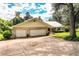House exterior with a large yard and two-car garage at 310 Willow Oak Ct, Fort Meade, FL 33841