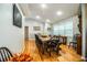 Bright dining room featuring a long wooden table and hardwood floors at 310 Willow Oak Ct, Fort Meade, FL 33841