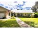 House exterior with walkway, and manicured lawn at 310 Willow Oak Ct, Fort Meade, FL 33841