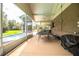 Screened patio with ping pong table, grill, and backyard access at 310 Willow Oak Ct, Fort Meade, FL 33841