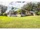Home's backyard features a large screened patio, above ground pool, and expansive lawn at 310 Willow Oak Ct, Fort Meade, FL 33841