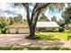 House exterior with a large yard and two-car garage at 310 Willow Oak Ct, Fort Meade, FL 33841