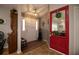 Inviting entryway with red door and wood flooring at 310 Willow Oak Ct, Fort Meade, FL 33841