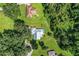 Aerial view of a home with a pool, surrounded by lush trees at 310 Willow Oak Ct, Fort Meade, FL 33841