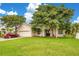 Tan house with a red car parked in the driveway at 2948 Vintage View Cir, Lakeland, FL 33812