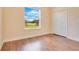Simple bedroom with wood floors and large window at 2948 Vintage View Cir, Lakeland, FL 33812