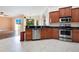 Modern kitchen with stainless steel appliances and wood cabinets at 2948 Vintage View Cir, Lakeland, FL 33812