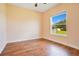 Well-lit bedroom featuring wood floors and a backyard view at 2948 Vintage View Cir, Lakeland, FL 33812