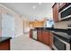 Kitchen with wood cabinets, granite countertops, and stainless steel appliances at 2948 Vintage View Cir, Lakeland, FL 33812