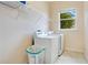 Laundry room with washer, dryer, shelving, and window at 2948 Vintage View Cir, Lakeland, FL 33812