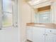 Bathroom with single sink vanity, toilet, shower/tub combo, and exterior access at 2948 Vintage View Cir, Lakeland, FL 33812