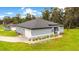 New construction home with gray exterior, landscaped yard, and driveway at 1896 12Th St, Orange City, FL 32763
