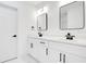Modern bathroom with double vanity, black accents, and white cabinets at 1896 12Th St, Orange City, FL 32763