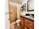Bathroom with granite countertop, wood cabinets, and shower at 2036 E Gachet Blvd, Lakeland, FL 33813