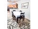 Dining area with a table, chairs and decorative rug at 2036 E Gachet Blvd, Lakeland, FL 33813