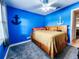 Nautical-themed bedroom with blue walls and a built-in bookshelf at 2036 E Gachet Blvd, Lakeland, FL 33813