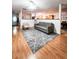 Bright living room with gray sofa and wood flooring, open to kitchen at 2036 E Gachet Blvd, Lakeland, FL 33813