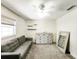Versatile bedroom with gray sofa and large dresser, perfect for guests at 2036 E Gachet Blvd, Lakeland, FL 33813
