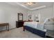 Well-lit bedroom with a dresser, mirror and en-suite bathroom access at 8218 Wilder Loop, Lakeland, FL 33809