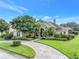 Beautiful two-story home with a landscaped yard and circular driveway at 6414 Highlands In The Woods St, Lakeland, FL 33813