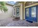 House entrance with a blue double door and stone detailing at 6414 Highlands In The Woods St, Lakeland, FL 33813