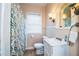 Updated bathroom with a shower/tub, white vanity, and a decorative shower curtain at 422 E Belmar St, Lakeland, FL 33803