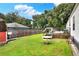 Backyard with grassy area, shed, and wooden fence at 4779 W Myrtle View Dr, Mulberry, FL 33860