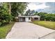 Brick ranch house with carport and large lawn at 415 Lucille St, Bartow, FL 33830