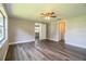 Bedroom with wood-look floors and access to bathroom at 415 Lucille St, Bartow, FL 33830