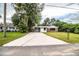 Brick ranch house with carport and large lawn at 415 Lucille St, Bartow, FL 33830