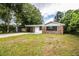 Brick ranch house with carport and large lawn at 415 Lucille St, Bartow, FL 33830